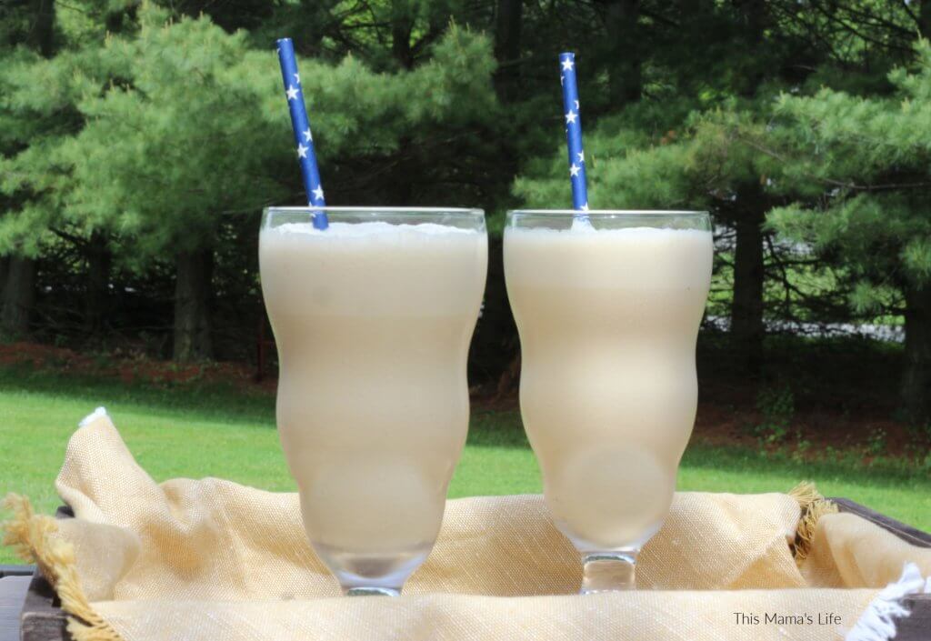 Coffee Milkshake in a large glass with a blue straw
