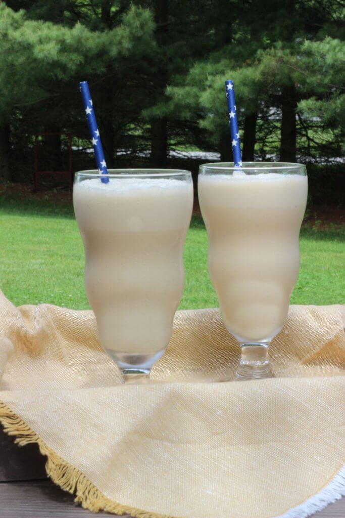 Coffee Milkshake in a large glass with a blue straw