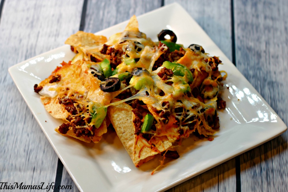 A tasty treat perfect for sharing! Top your Nachos with Green Pepper, Onions, Cheese and Lindsay Olives